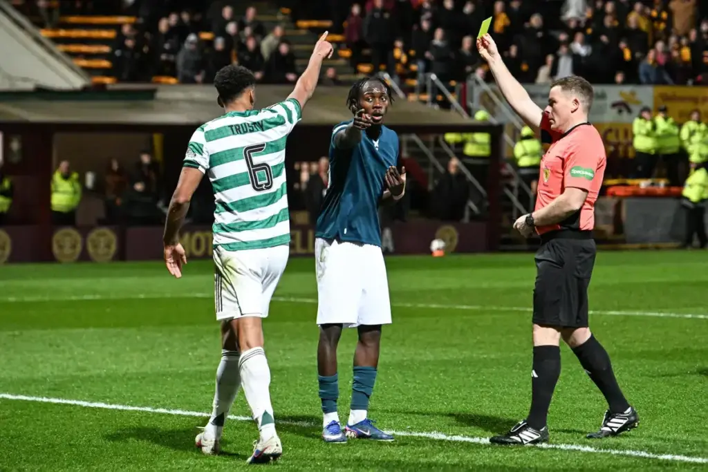 Referee John Beaton shows Emmanuel Longelo of Motherwell a yellow card as Auston Trusty points during the William Hill Premiership match at Fir Park, Motherwell 13/05/2026