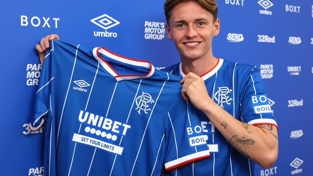 James Penrice posing with a Rangers kit.